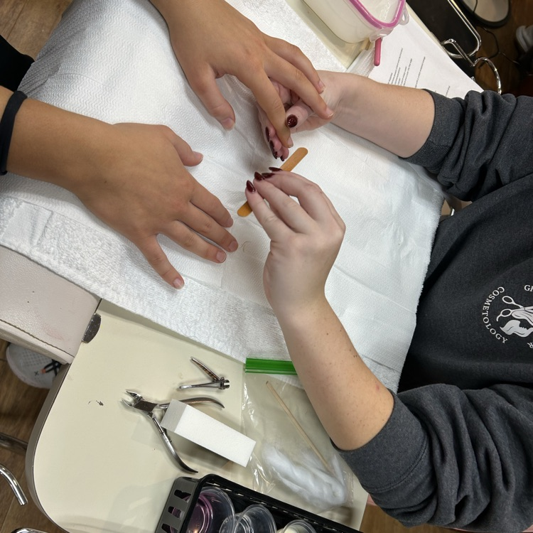 junior cosmetology students taking in some clients from other programs for manicures!