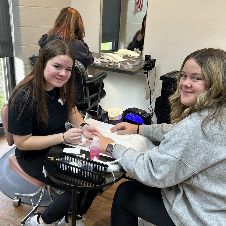 junior cosmetology students taking in some clients from other programs for manicures!
