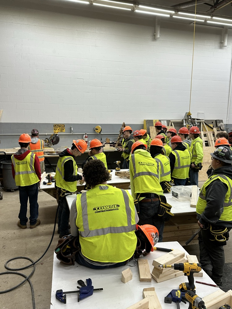 Kenny Carter demonstrates angle cuts on a mitre saw. Students utilize these skills in order to build their Christmas tree projects.