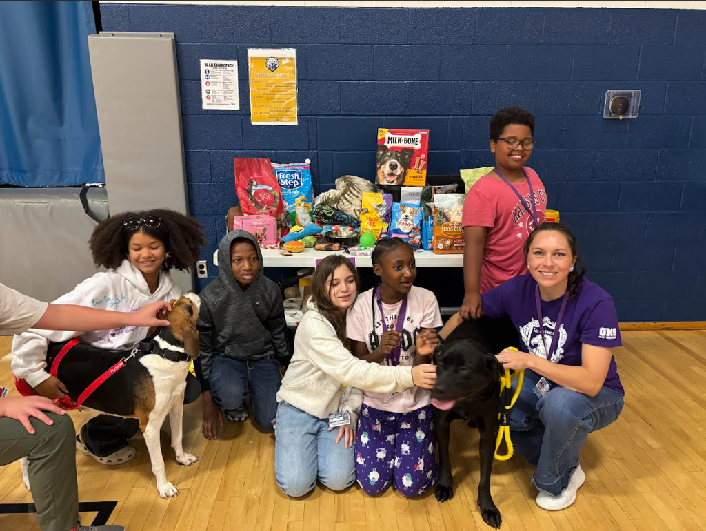 Resiliency Lodge students with donations and the adoptable shelter dogs!
