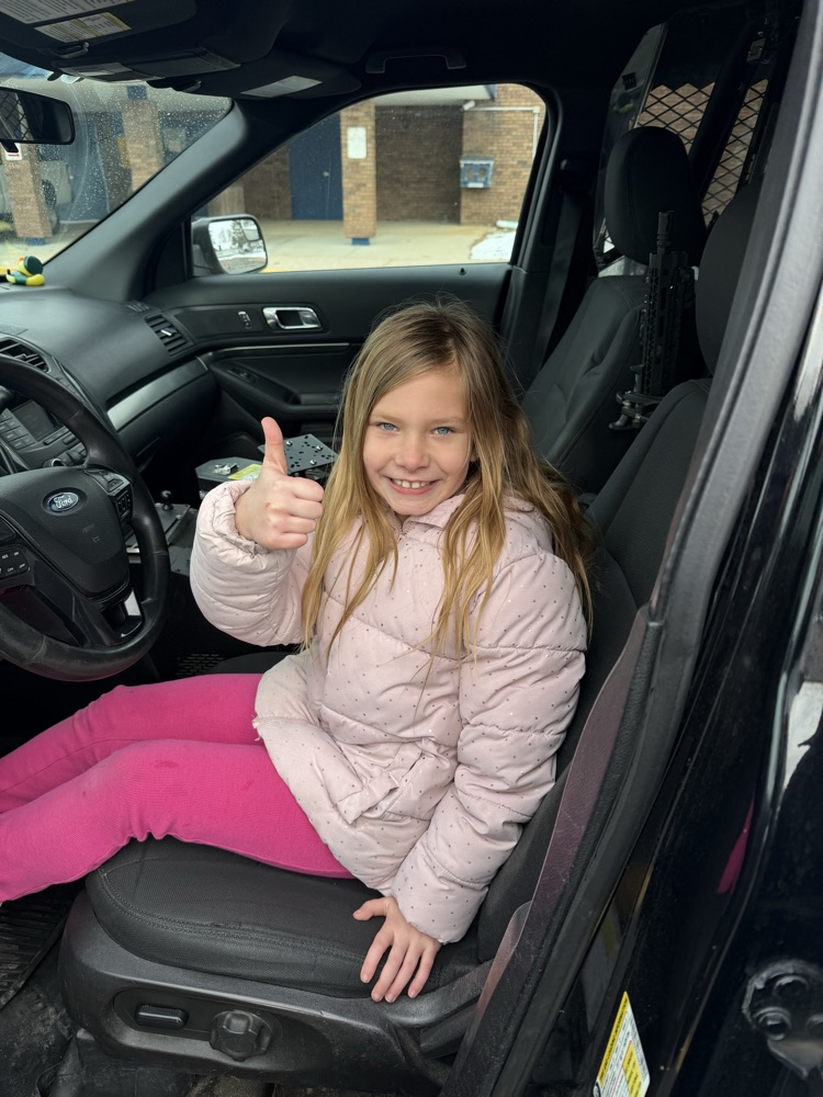 Second grade students excited to sit in Officer Stitt’s car. 