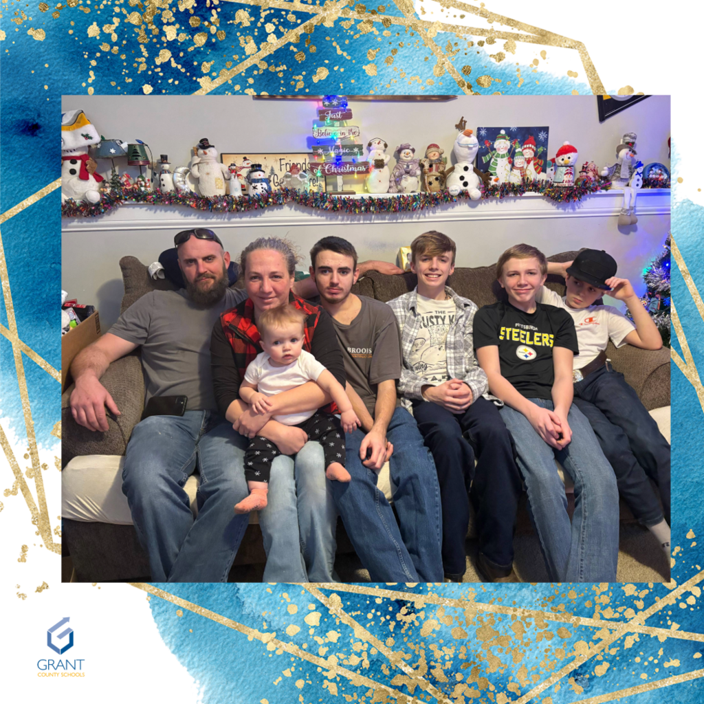 family of seven sitting on a couch.
