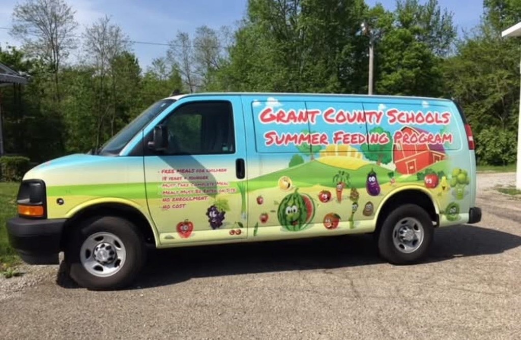 colorful van with vegetables on the side