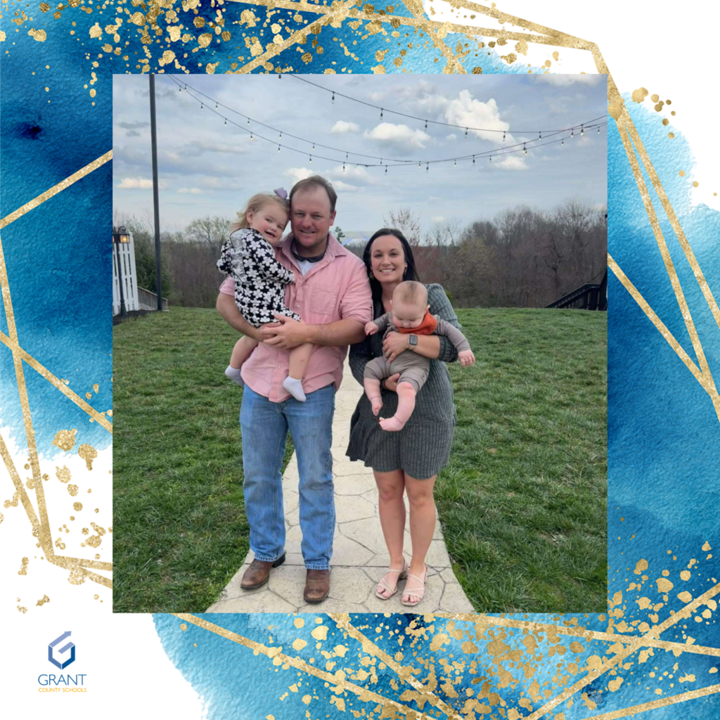 Man, Woman, two children outside.