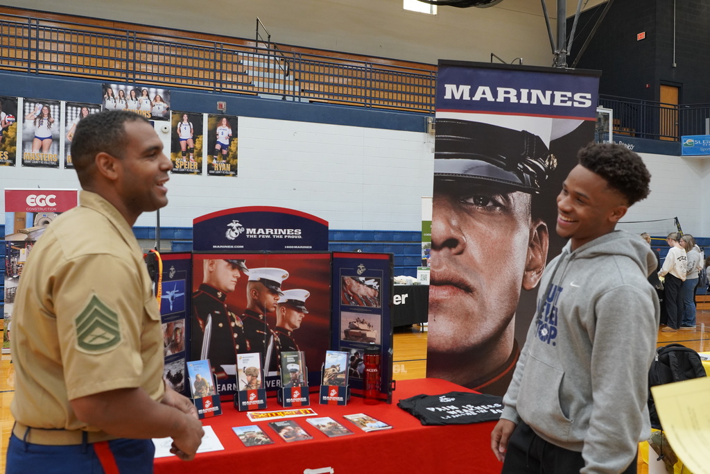 two men talking in a gymnasium