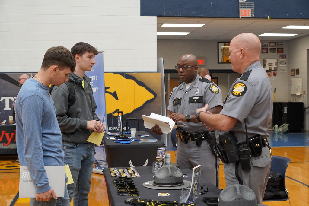 young men talking with state policemen