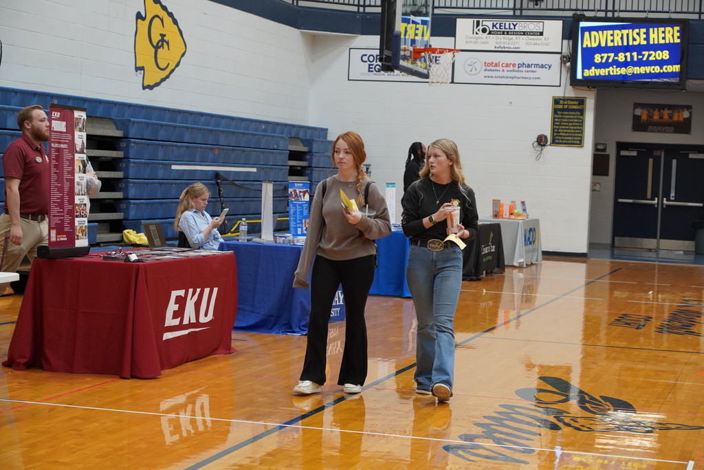 two girls walking through a gymnasium