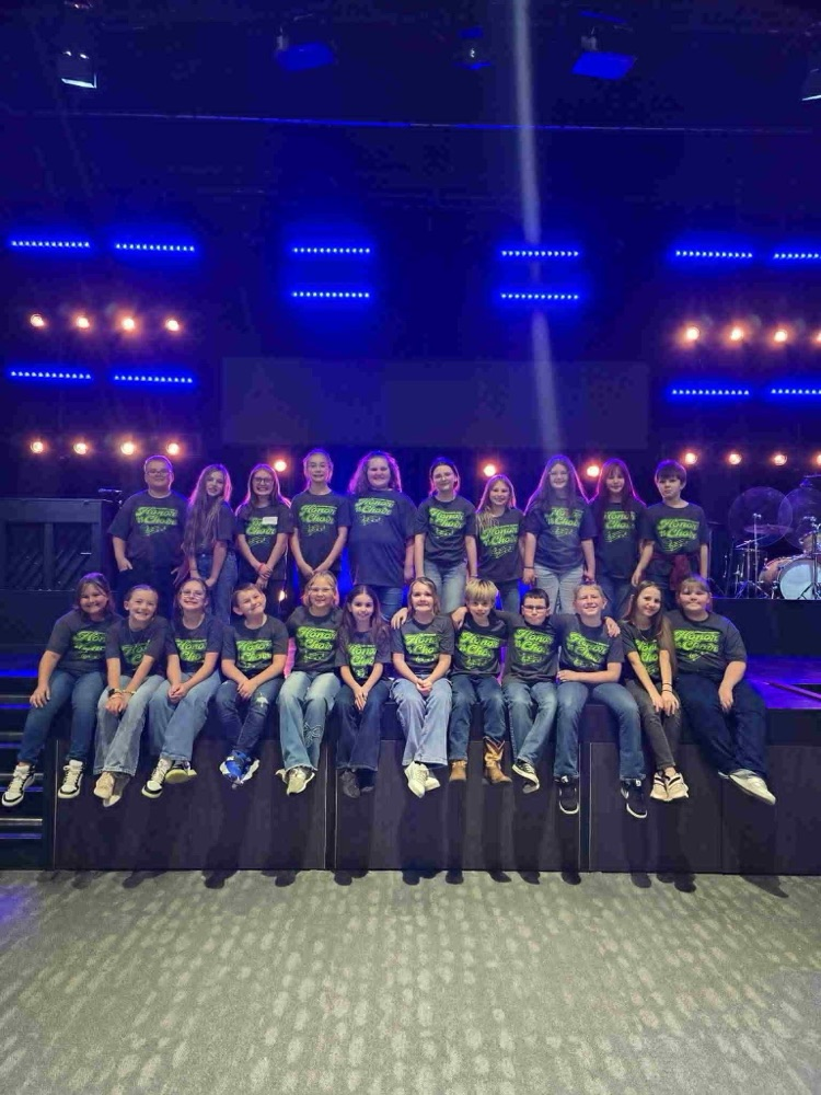 children sitting on a stage