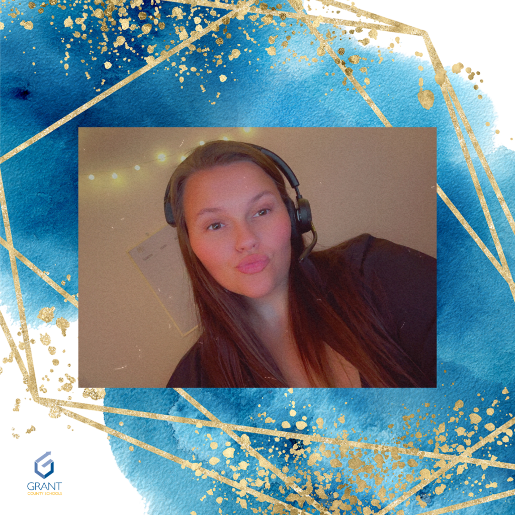 Woman in Brown with a headset on.