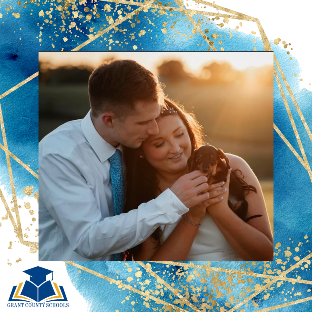 Woman and man holding a puppy