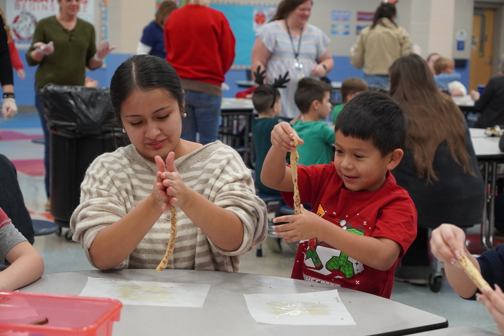 woman in grey stripes and boy in red