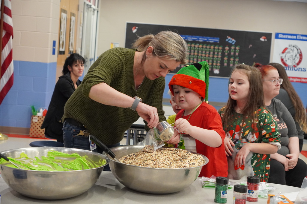 boy in elf hat, woman in green