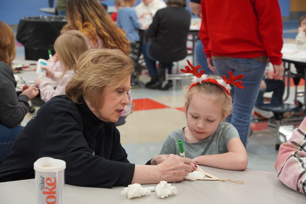 woman in black, girl in reindeer antlers