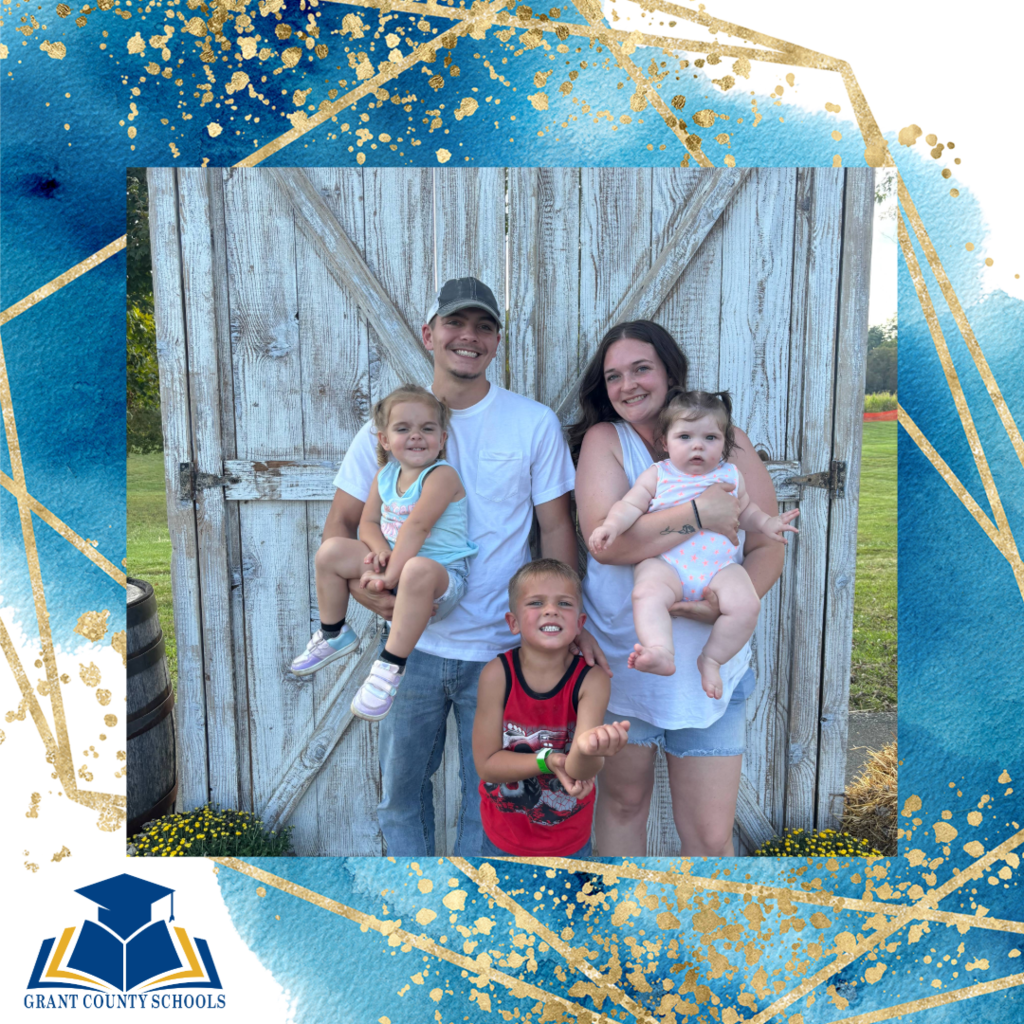 man, woman, three babies outside