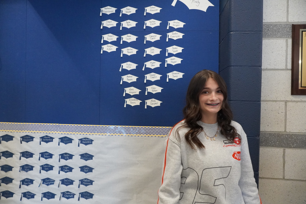 Girl smiles beside her name