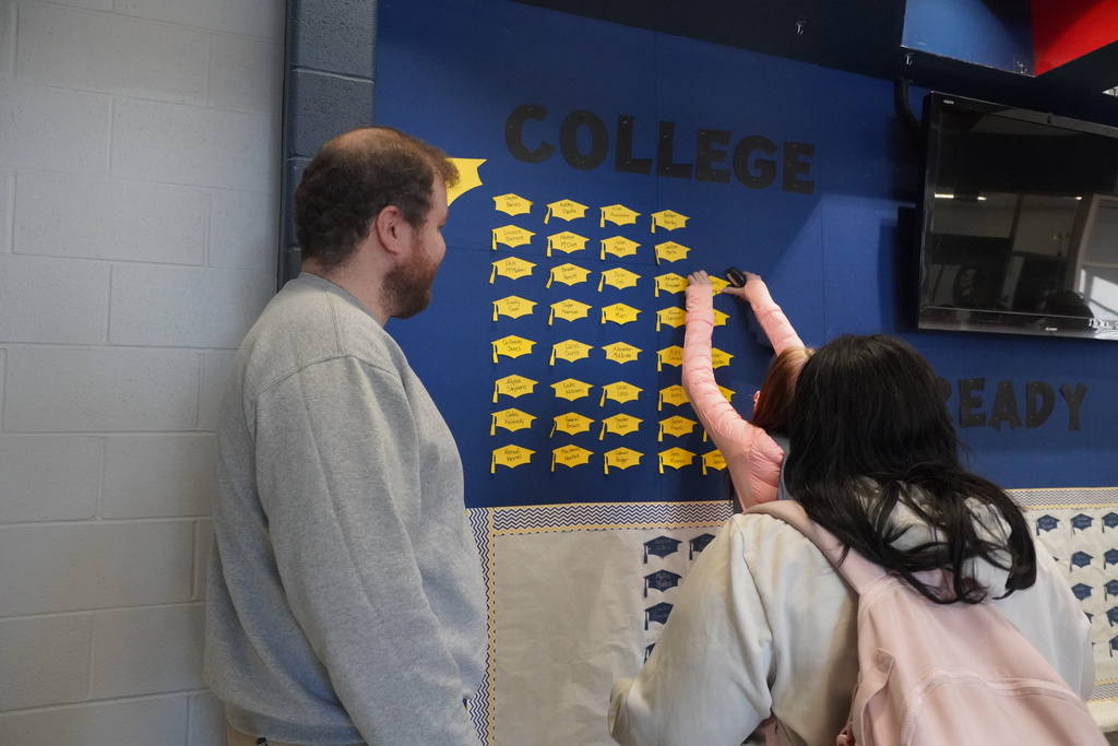 Girls staples her name on the wall