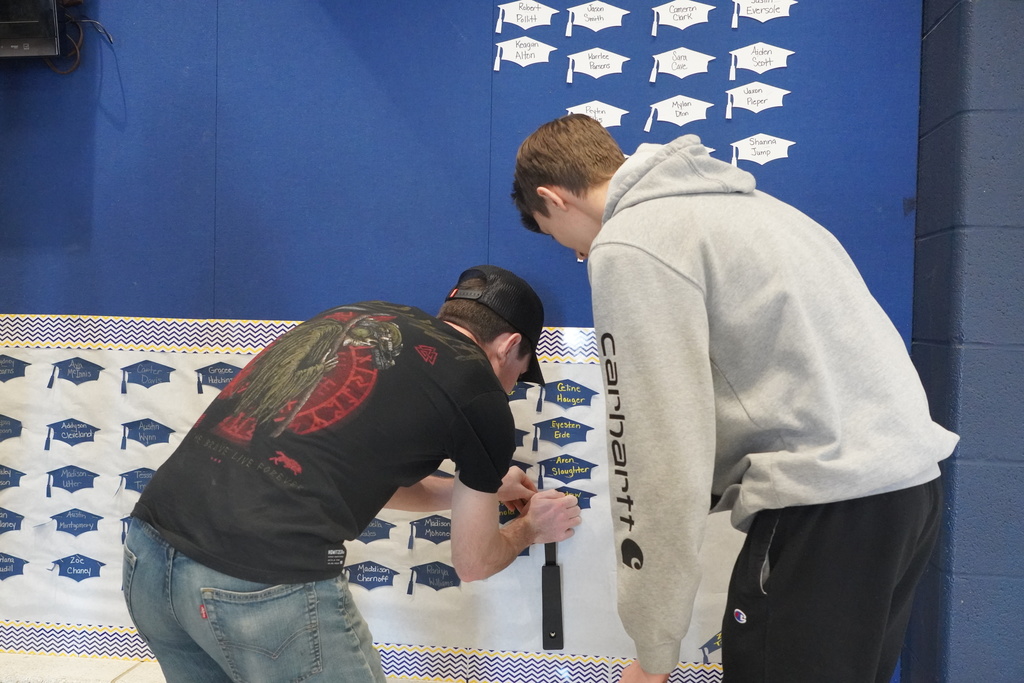 Boy Staples his name on the wall