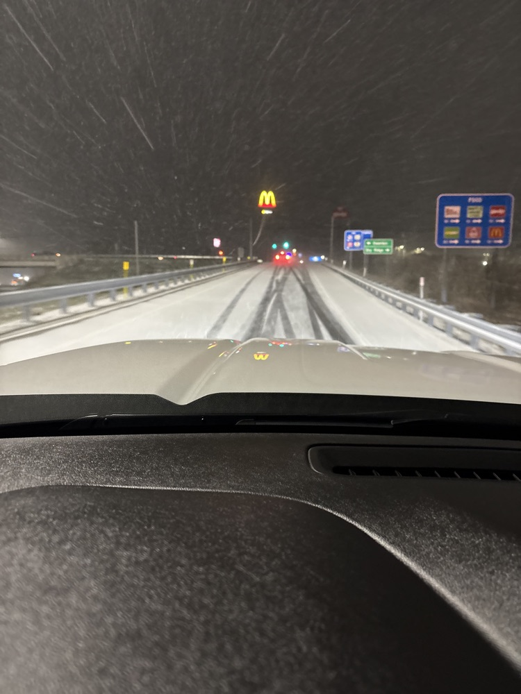 snow covered road in the dark