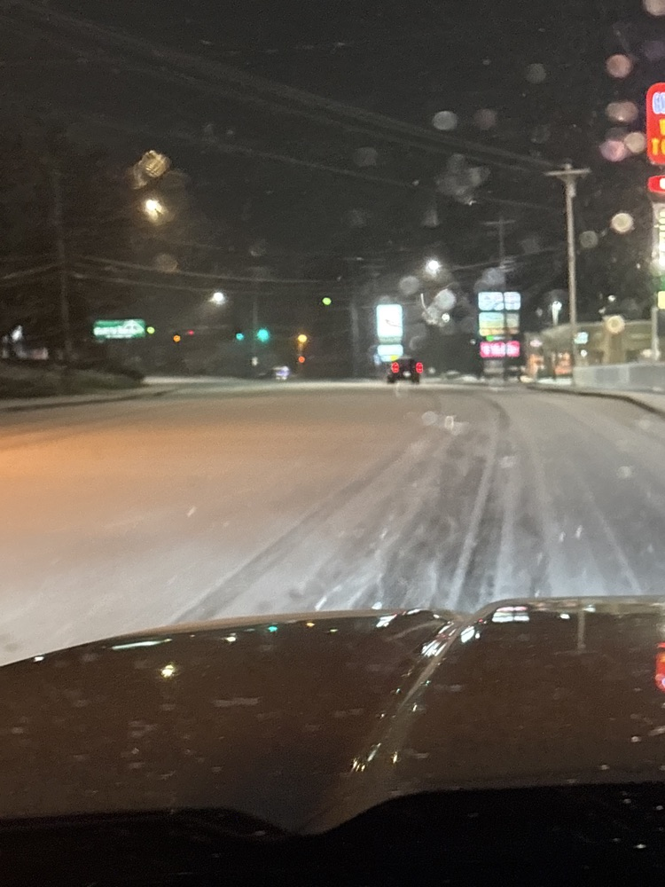 snow covered road in the dark