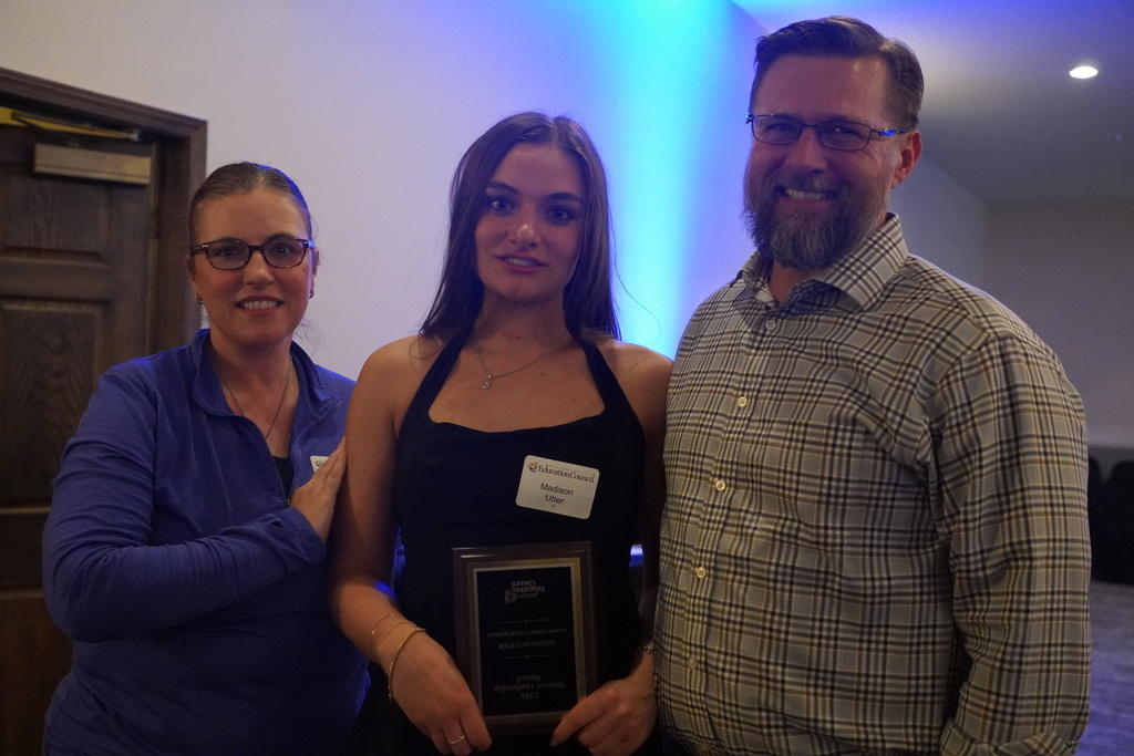 Woman with glasses, young woman with brown hair, man with glasses