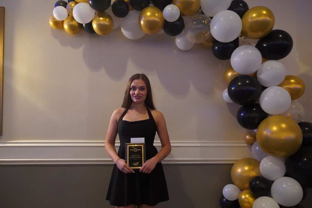 girl with brown hair and gold balloons