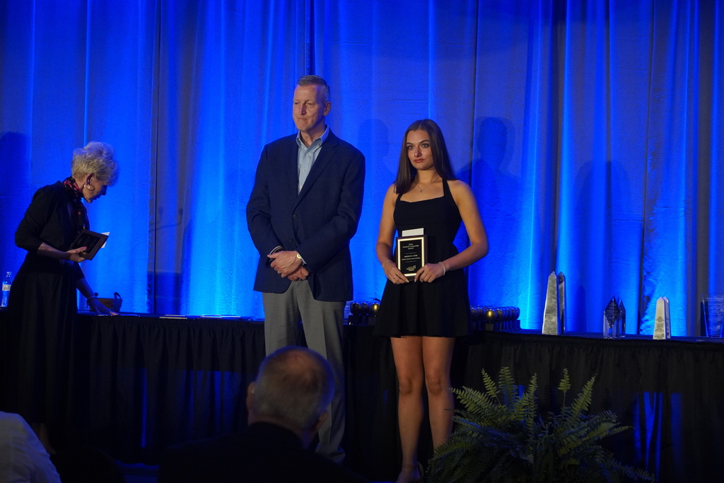 girl with brown hair and a blue background