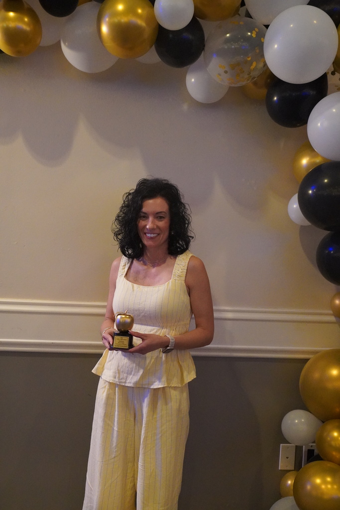 Woman in yellow surrounded by balloons
