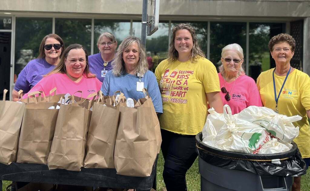 Seven women and food bags