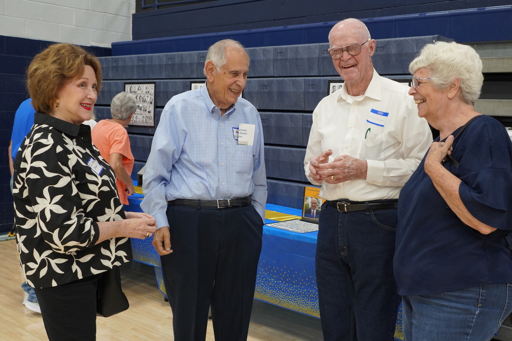 two men and two women speaking