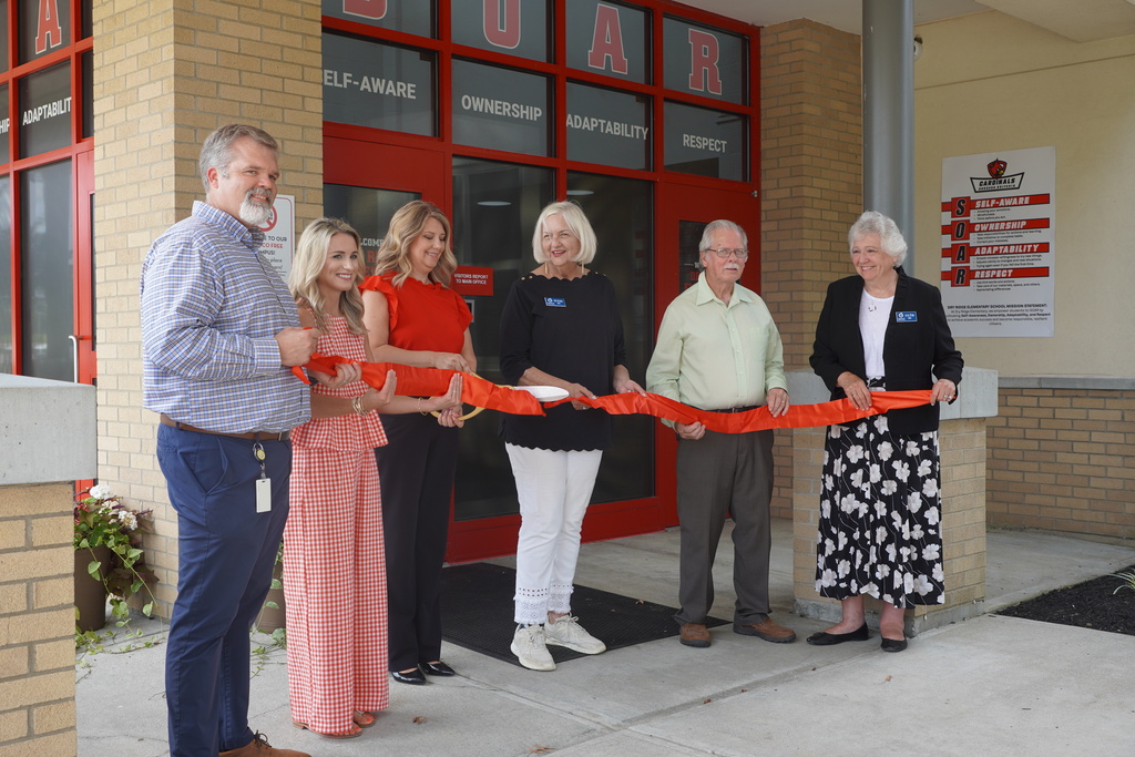 ribbon cutting with four men and two men