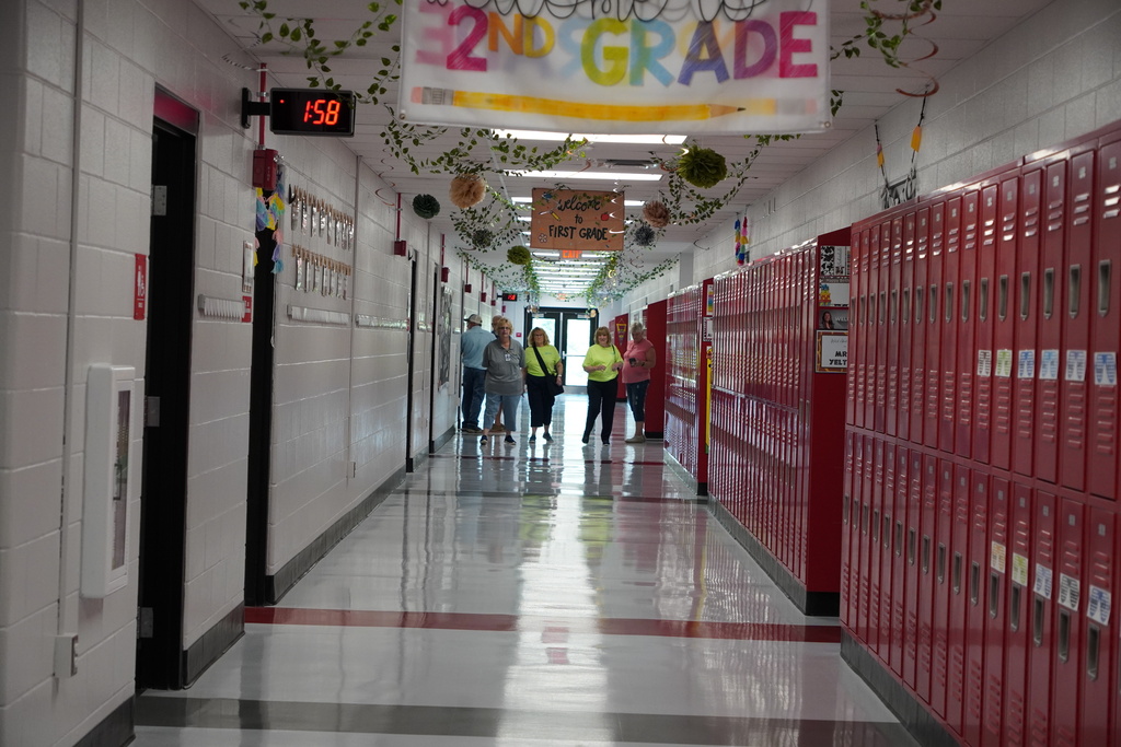 Long hallway with red lockers