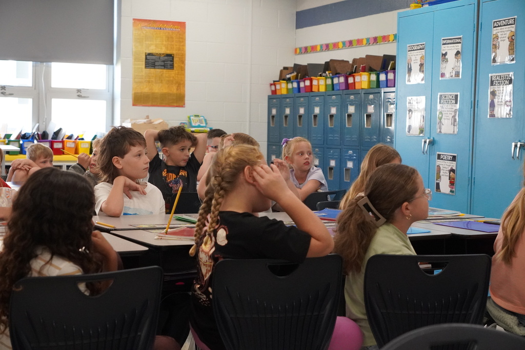 classroom of children listening to the teacher