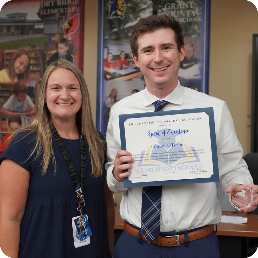 Female and Male smiling with a certificate