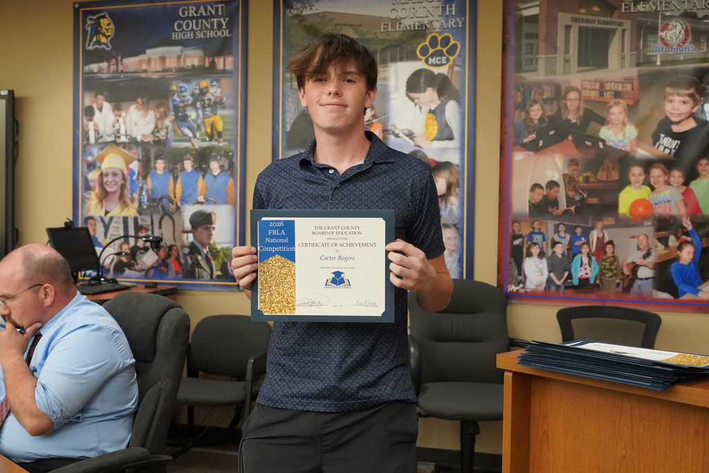 Male student smiling with a certificate