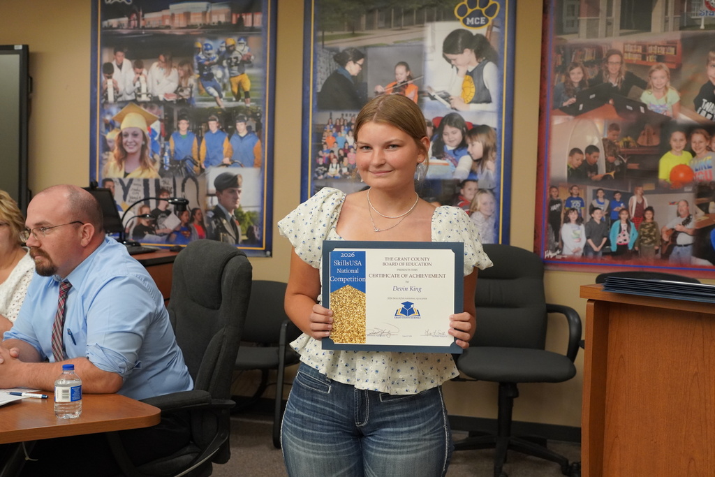 female student smiling with a certificate
