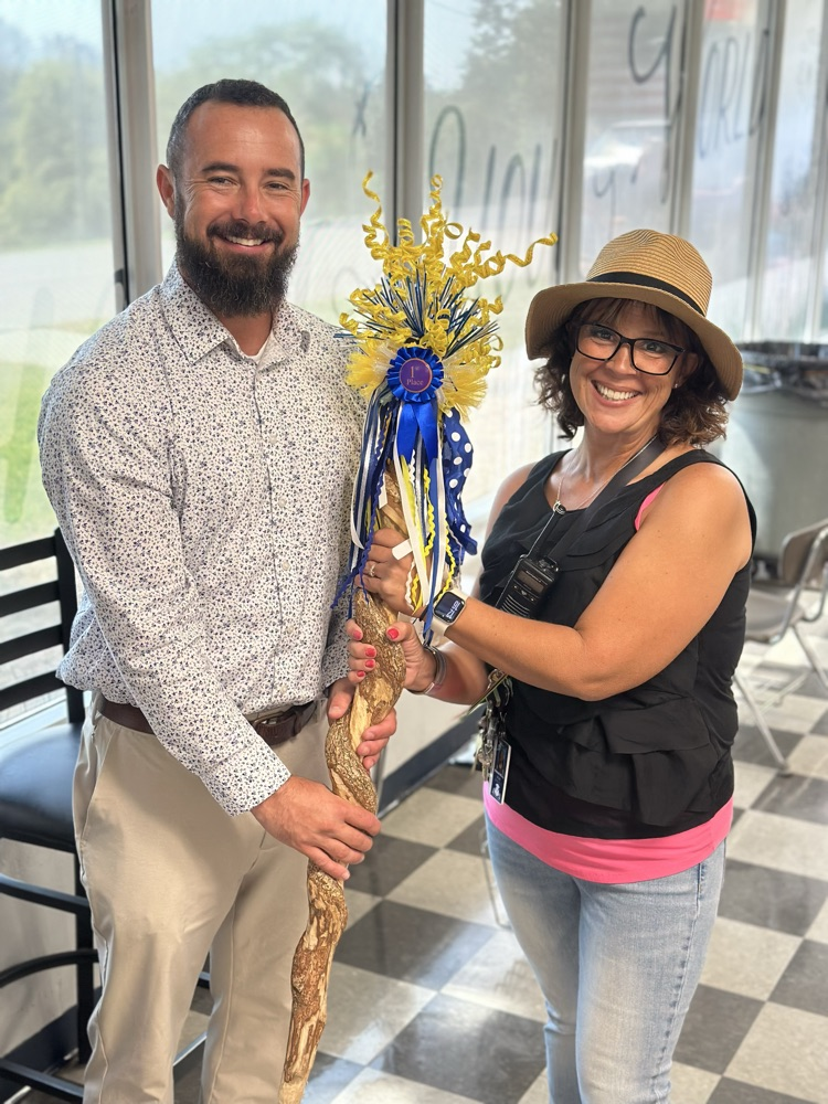 man and woman holding the spirit stick