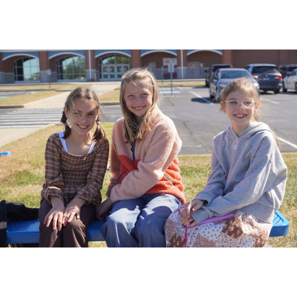 three young girls smiling