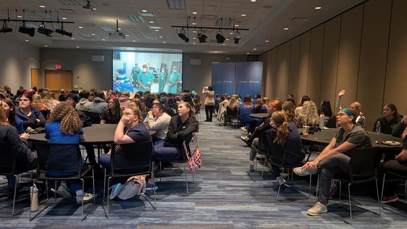 Students engaging in a large room