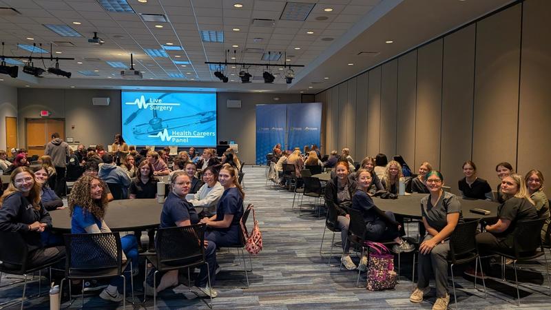 Students smiling in a large room