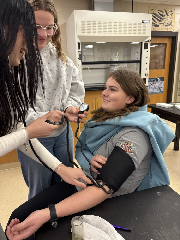 Students taking blood pressure  