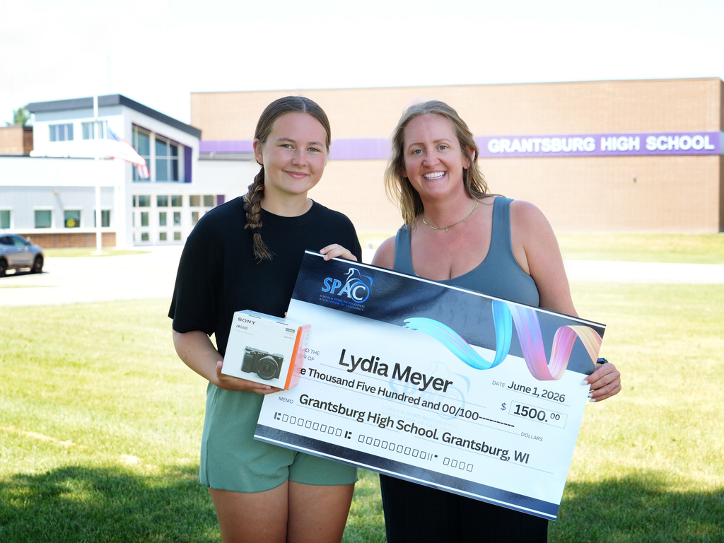 Lydia receives a scholarship check and camera