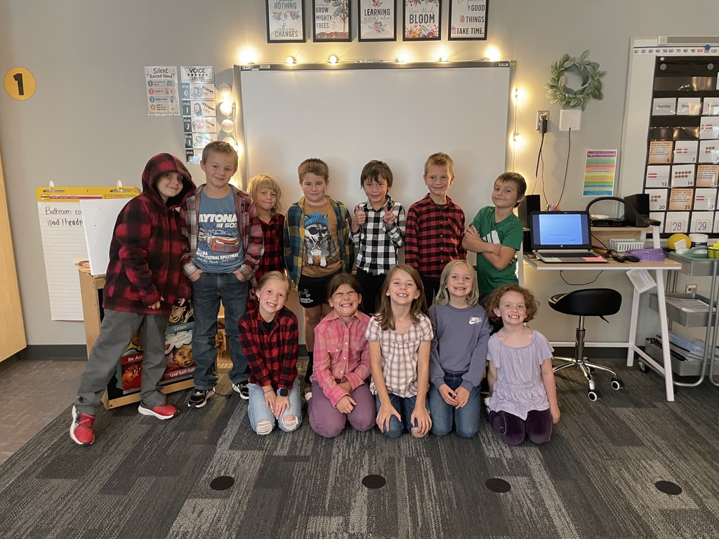 A group of second grader's smile for a picture to celebrate Flapjacks & Flannel Day!