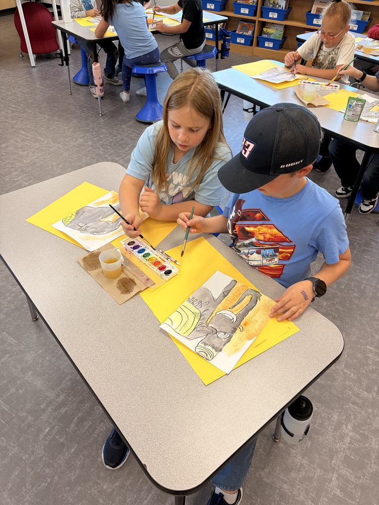 Two students create sunset backgrounds for their elephants.