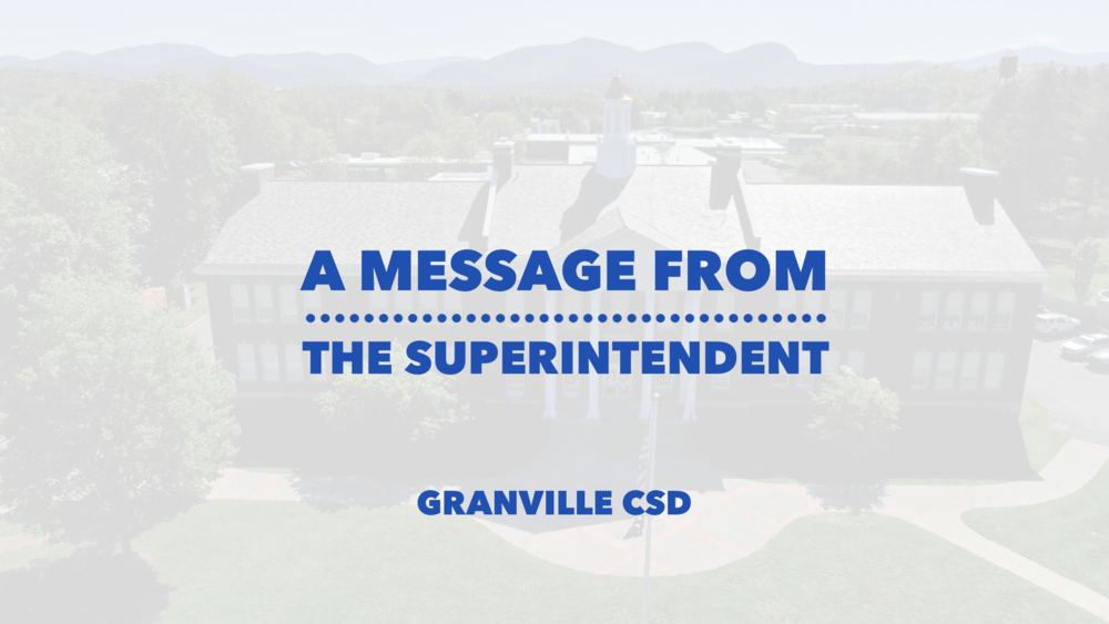 A message from the superintendent written in blue font over a blurred image of the Jr/Sr High School front lawn