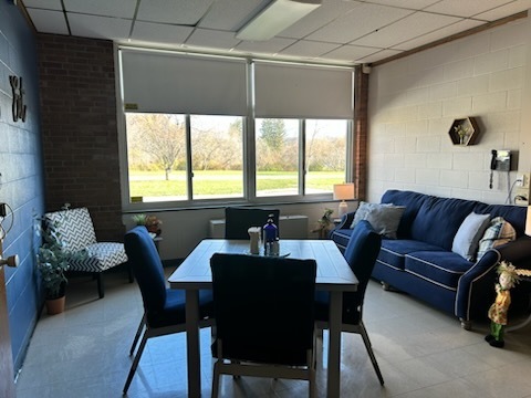 After: MJT Makeover picture of comfortable blue chair and couch and new tables and fresh paint and decor