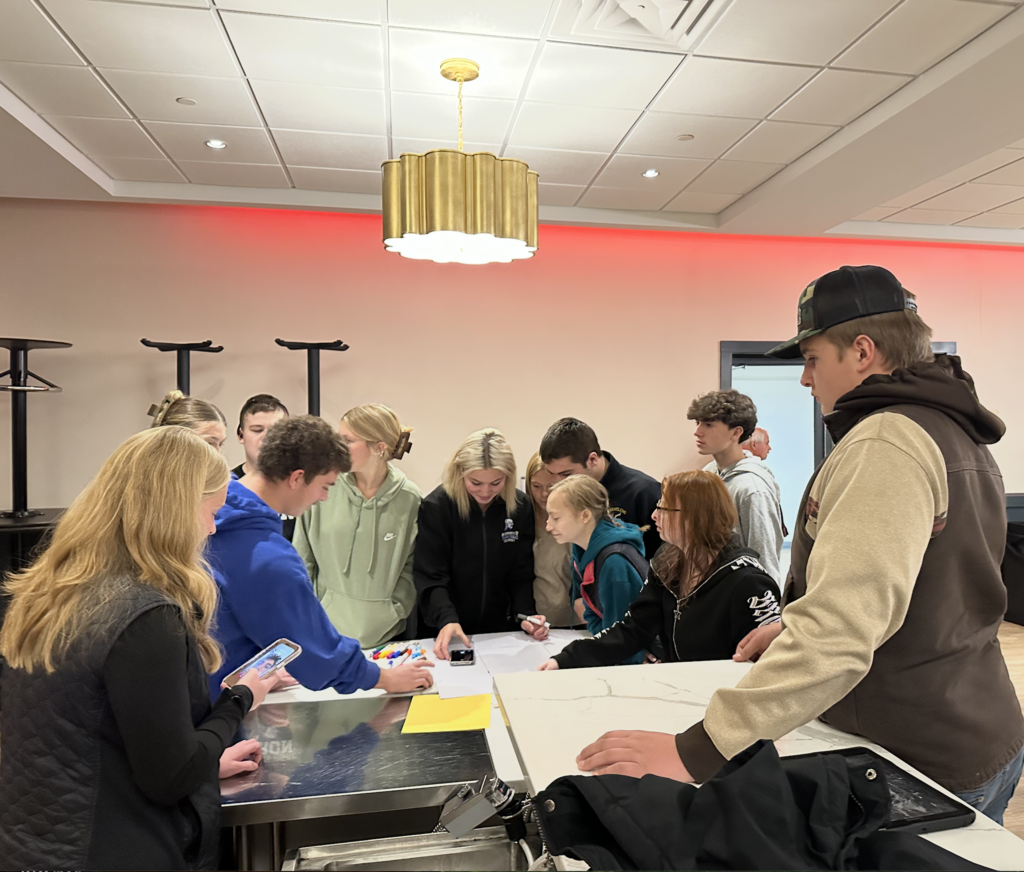 A group of unified sports students working together on a poster