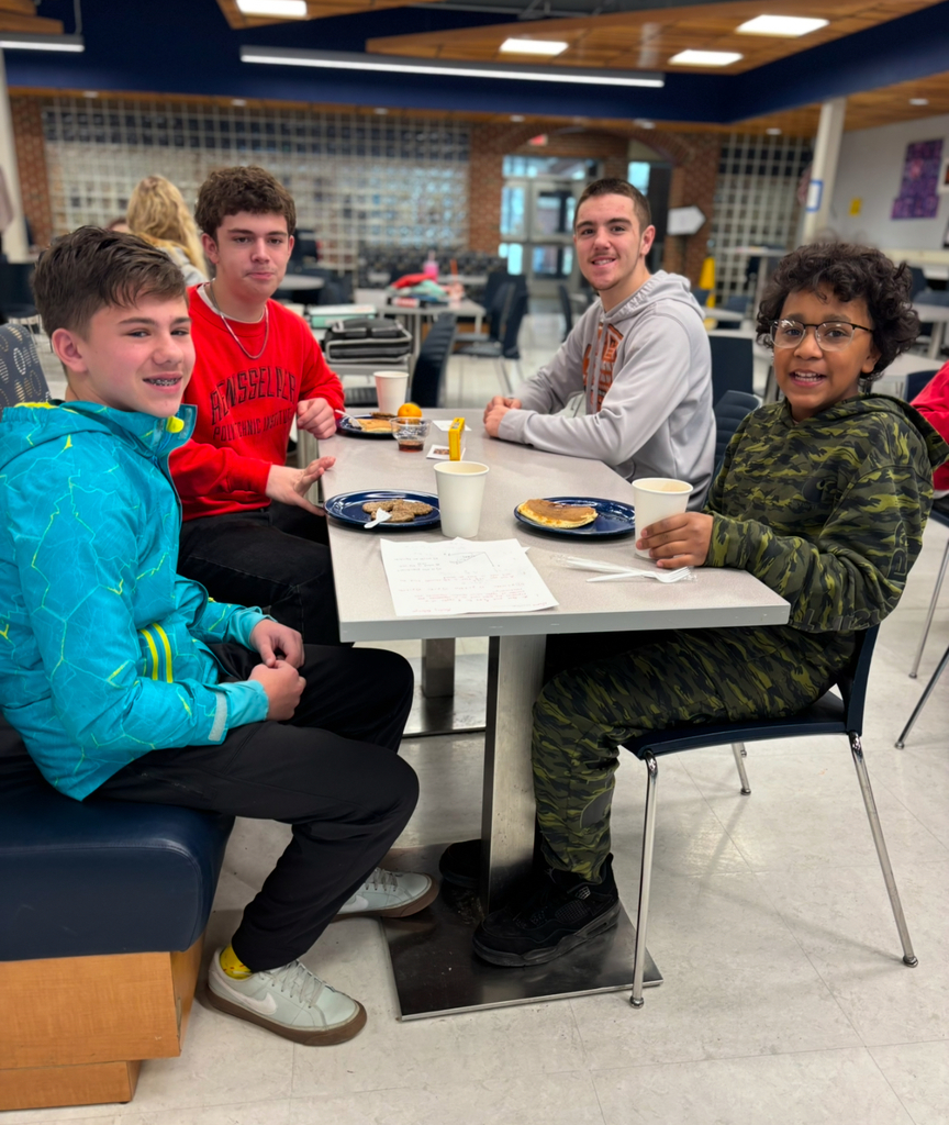 Two groups of mentors and their mentees enjoy breakfast together