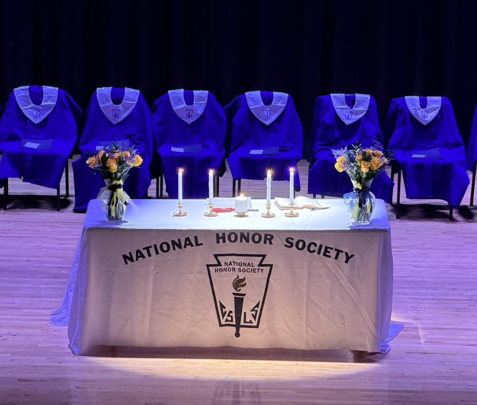 Four candles representing the four National Honor Society pillars - scholarship, service, leadership and character. 