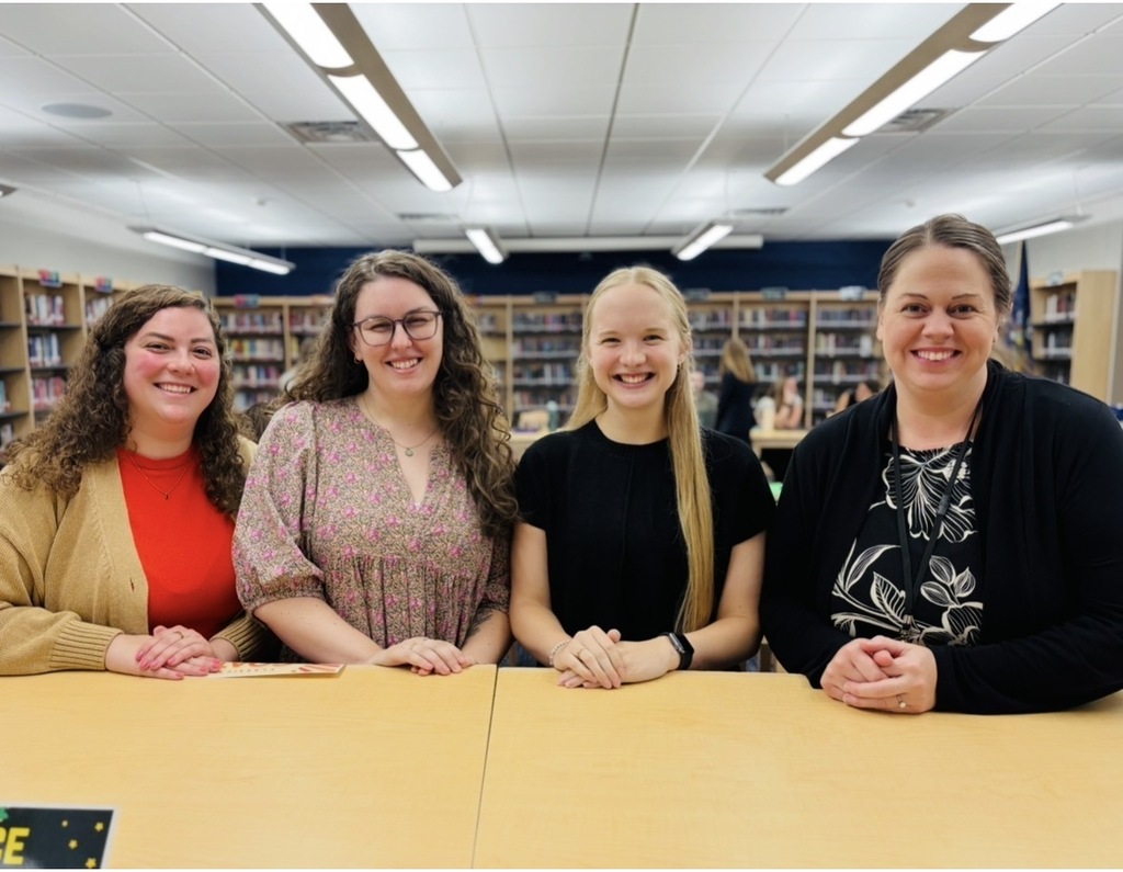 New MJT Staff (4 teachers standing in the library behind a waist height bookcase). Left to Right - Macy Dufrain, Devin Weller, Rebecca Kohls, and Ashley Siepman, MJT School Counselor. Go Horde!