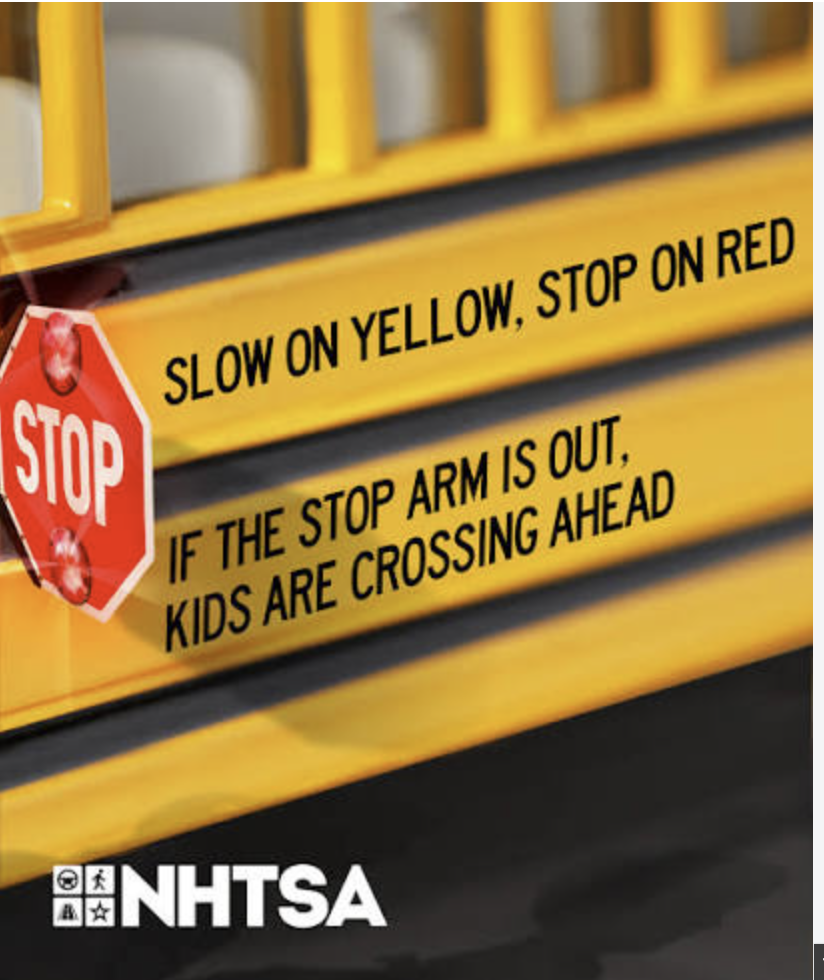 An image of the side of a school bus with black font with the words: slow on yellow, stop on red. If the stop arm and red flashing lights are out, kids are crossing ahead
